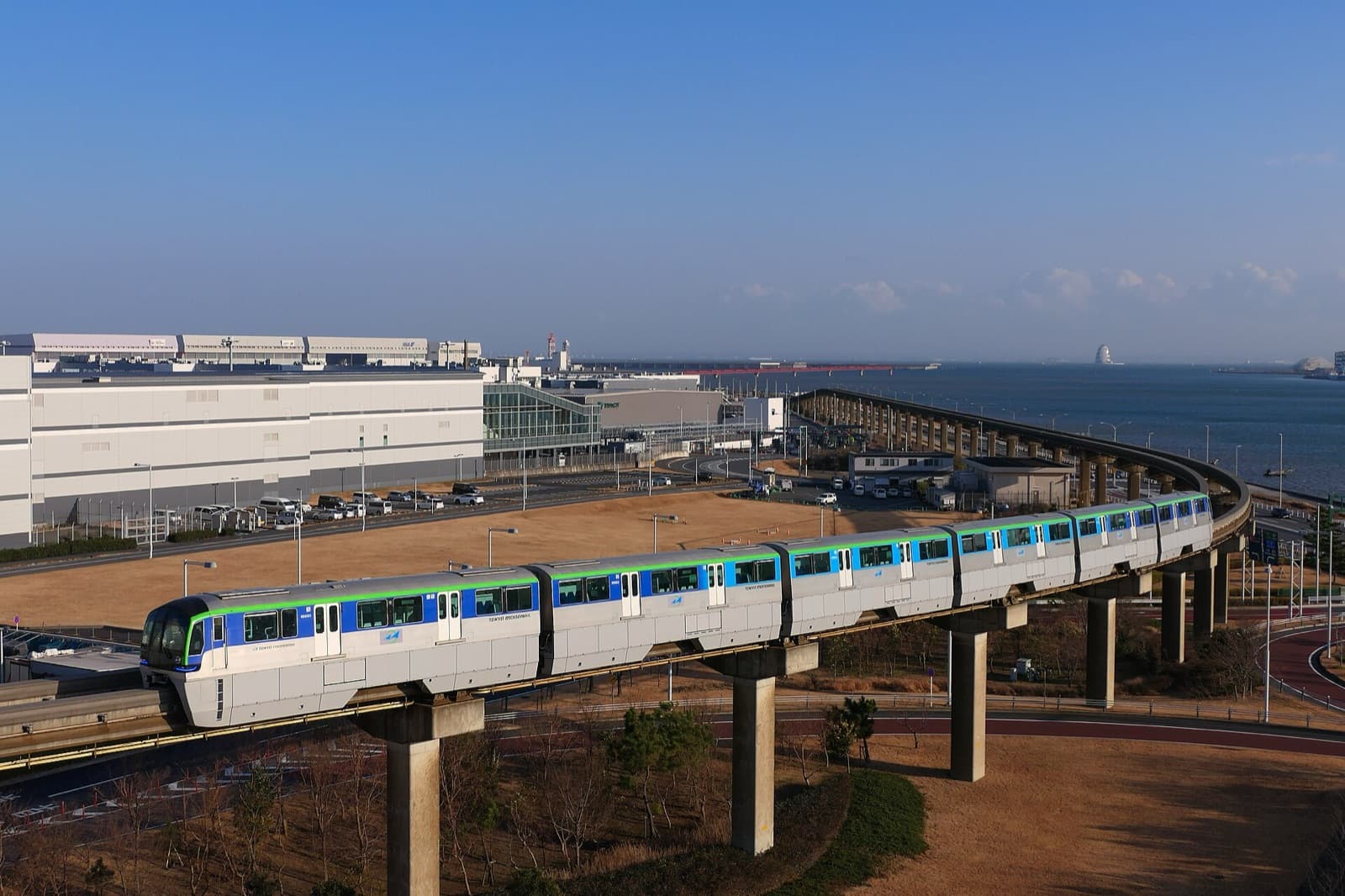 A Tokyo Monorail train on the elevated track beside Haneda Airport and Tokyo Bay