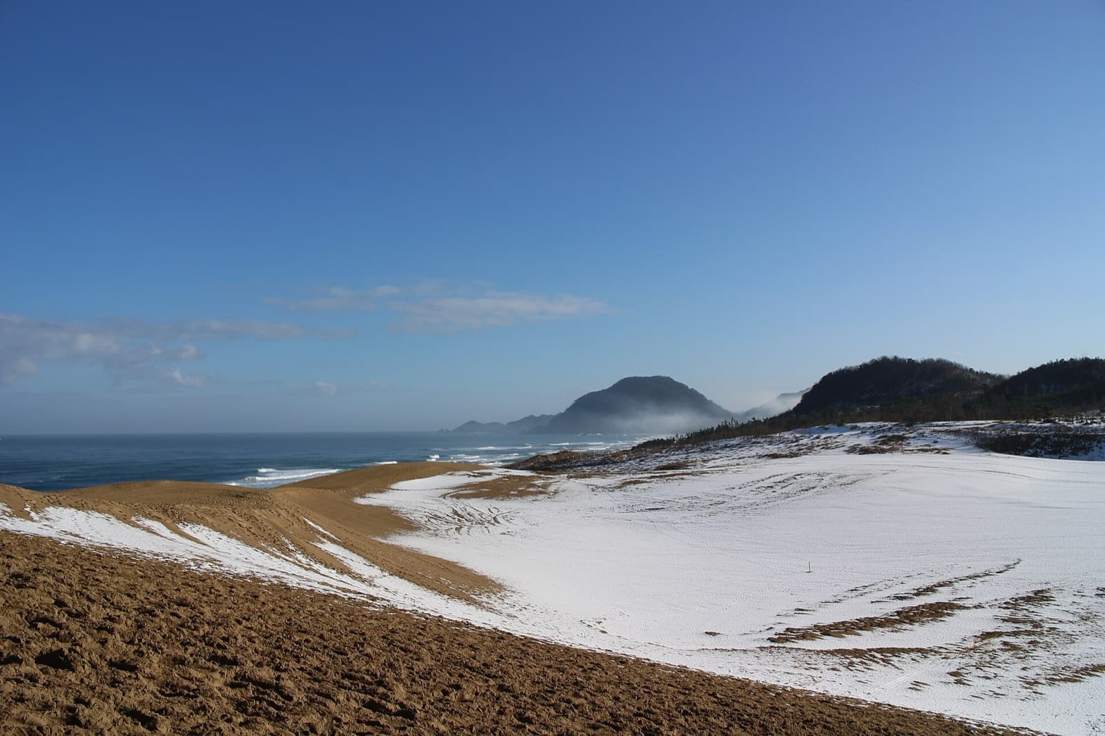 Tottori's sand dunes after snow, with the Sea of Japan beyond